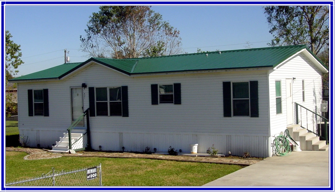 Green metal roof on a white manufactured home